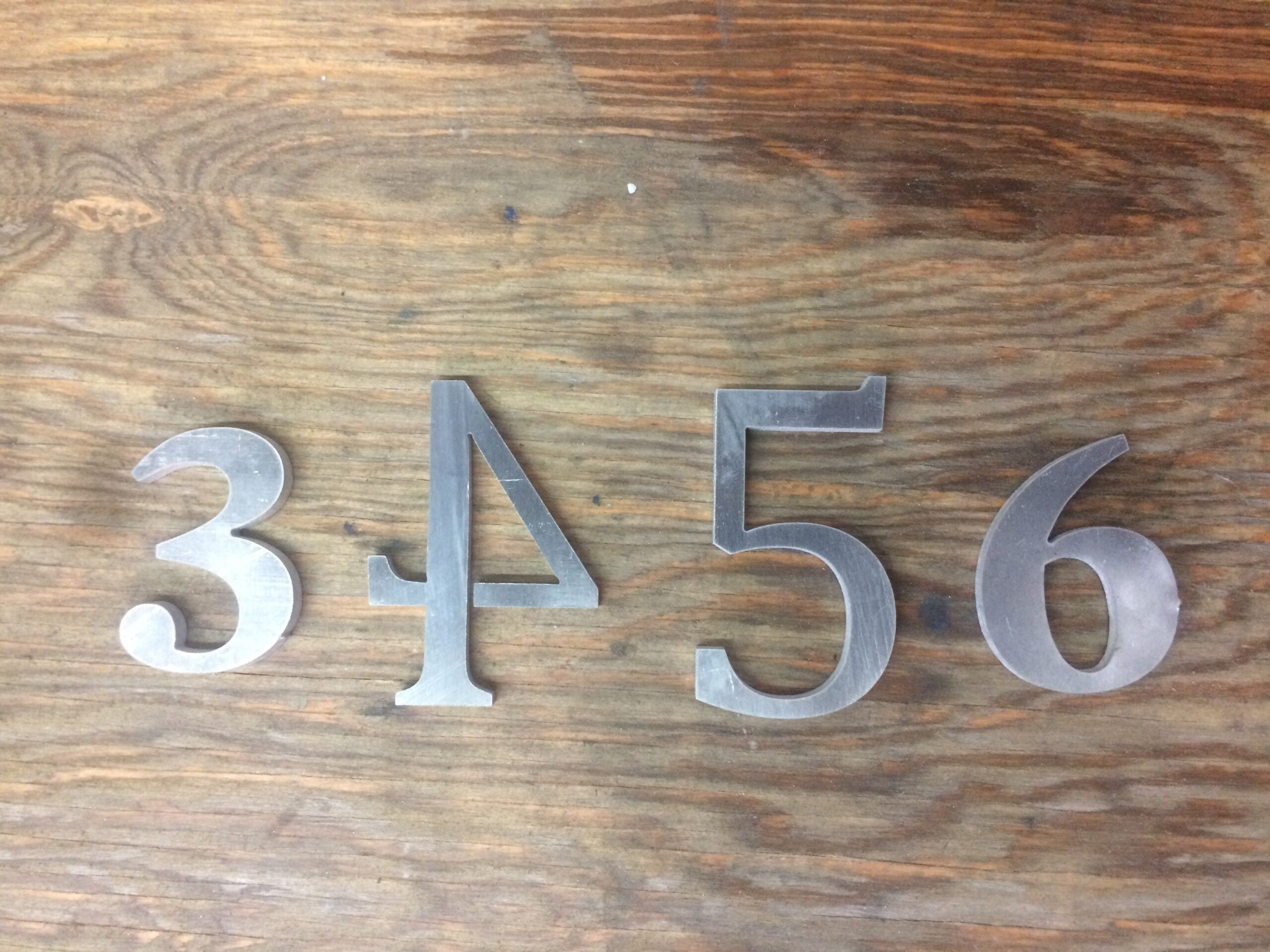Water jet cut aluminum sign numbers